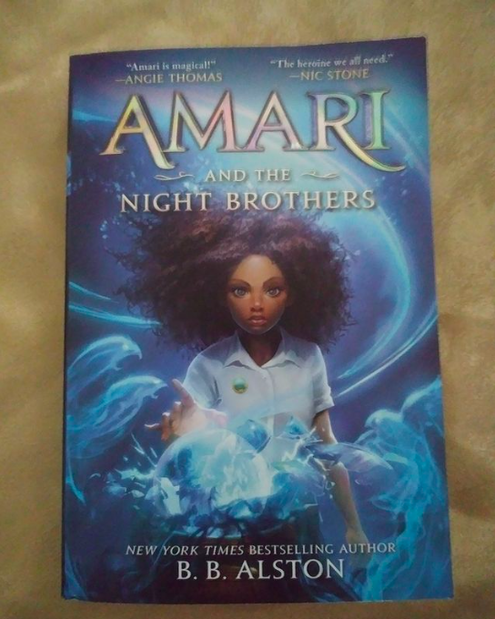 Amari and the Night Brother's book cover over a gold background